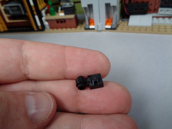 As shown in the first photo for this step, remove the second of the two black LEGO plates with open side hole from the bag inside of BOX 1.
