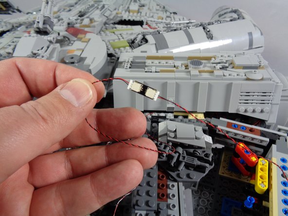 On the inside right rear of your Falcon, just behind the area where the boarding ramp is located, there should be an adapter with multiple large plugs.