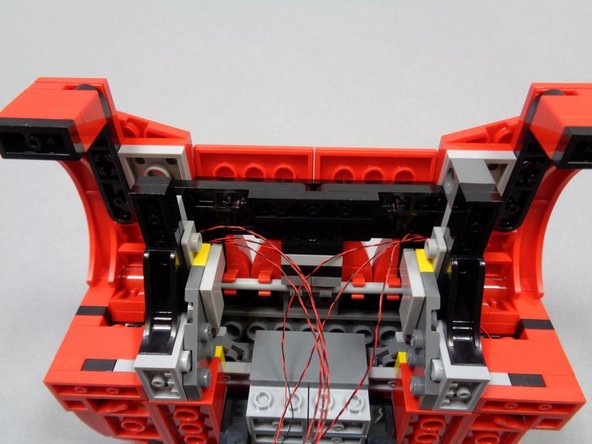 As shown in the first photo, you should now have two sets of headlight wires coming into the center part of the underside of the hood.