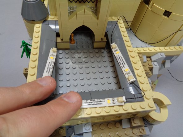 As shown in the second photo, connect the light strips end-to-end so a string is created with the longer cable on one end of the string.