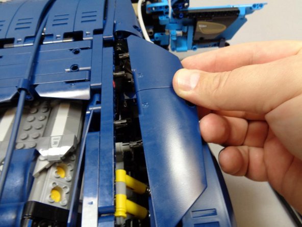 As shown in the first photo, remove the right Technic panels at the rear of the vehicle.