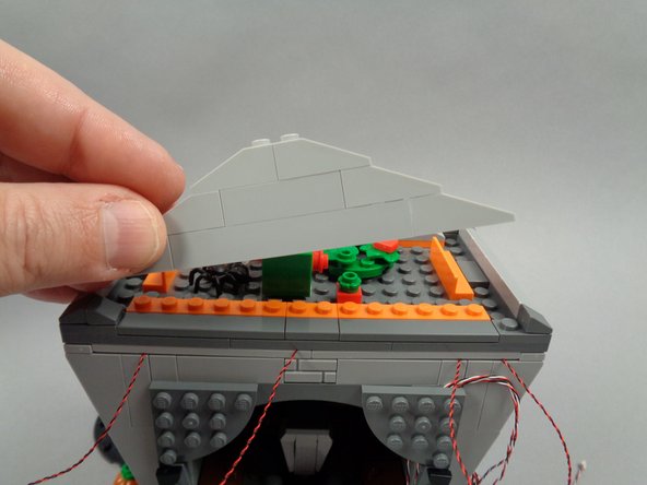 Remove the top rear roof frame section of the town hall, as shown in the first photo.