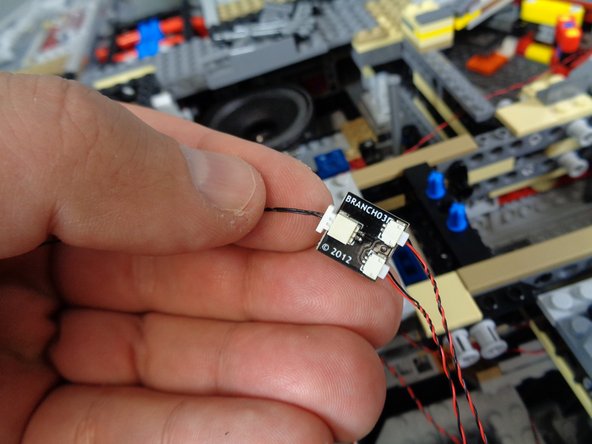 Using the illustration in the previous step as a guide, connect two landing lights to the small connectors on the BRANCH03/A3 adapter board as shown in the first photo.  Connect one end of the 12&quot; connecting cable to the large plug on the BRANCH03/A3 adapter.