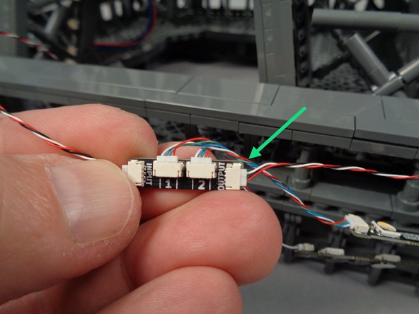 As shown by the green arrow in the photo for this step, connect another 3-wire control cable to the OUTPUT plug on the adapter board.