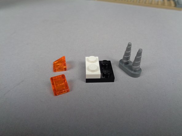 As shown in the two photos for this step, carefully remove and disassemble the fireplace on the side of the mansion closest to the front door.