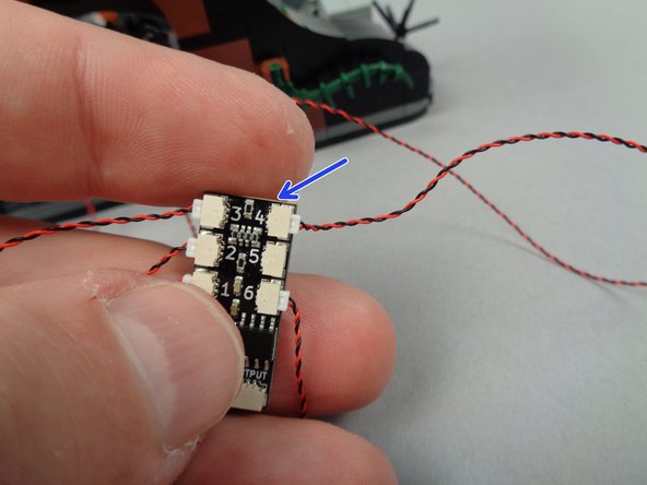As shown by the arrow in the third photo for this step, connect the LED light wire to plug #4 on the BRANCH06X driver board.