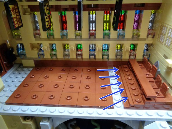 As shown in the second and third photo, remove the brown benches and also the brown tile in front of the raised chairs (blue arrows in the third photo).