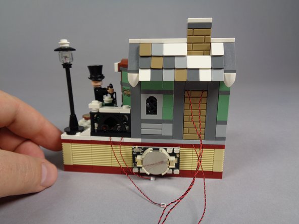 When you are finished, the back of your model should look like the third photo, with five light wires passing toward the battery pack.