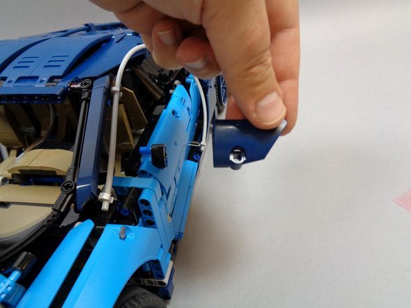 As shown in the second photo, remove the LEFT rear-view mirror-- this will make it easier to turn the car on its side in the following step.