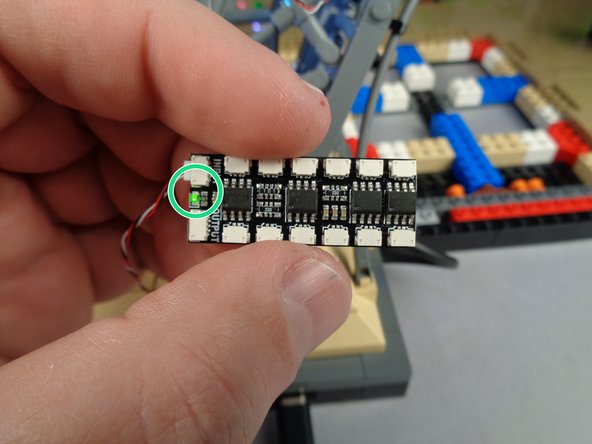 As shown by the green circle in the second photo, you should see the green LED light light up on the BRANCH12X driver board.