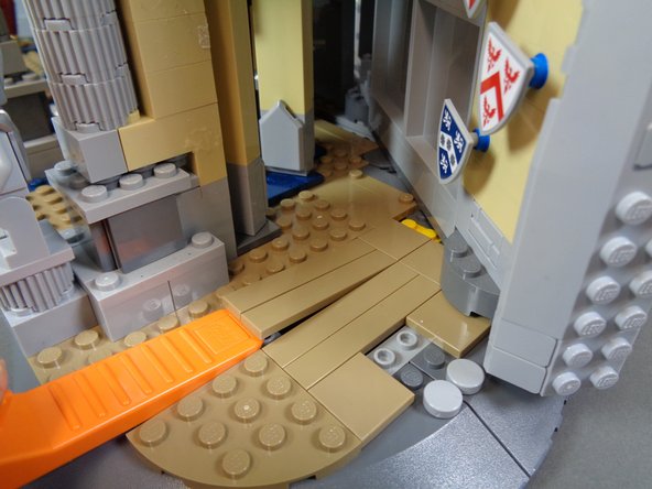 As shown in the first photo for this step, use a brick separator to remove the two long dark tan tiles from the castle floor.
