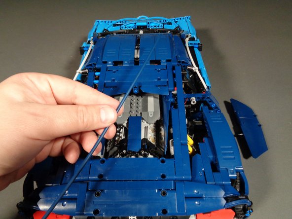 As shown in the two photos for this step, continue disassembly of the rear panels.