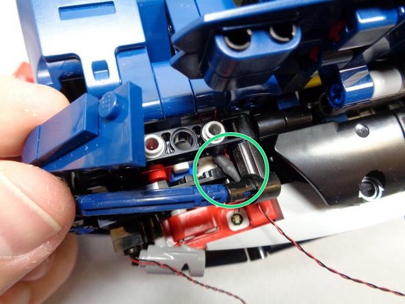 As shown in the third photo, you may need to remove some parts on top, and possibly the large black plate on the rear of the car itself, in order to route the tail light wires.