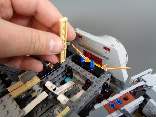 Re-attach the docking bay cap, making sure to pull the bottom light wires fully through the Technic bricks so the bottom light wires don't get pinched when the cap is re-attached.