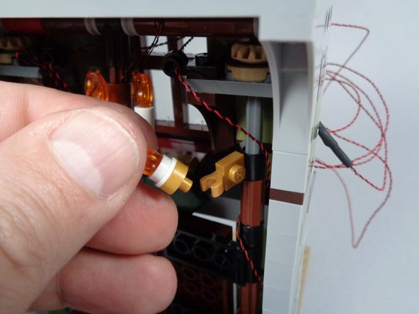 As shown in the second and third photos for this step, remove the left and right un-lit sconces from your mansion entryway.