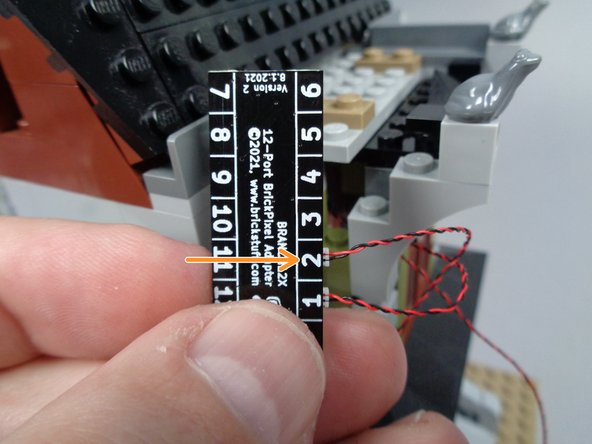 The orange arrow in the third photo shows the back side of the BRANCH12 adapter with the front porch light connected to plug #2.