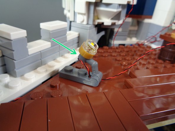 You can use a variety of techniques to mount and angle the spotlights.  There are dark bluish gray plates and jumper plates in the &quot;Lower Level Lights and Parts&quot; bag that you can use to attach and angle the lights.