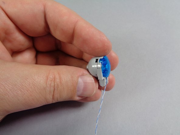 As shown in the first photo for this step, re-attach the dome to the back side of the blue light.