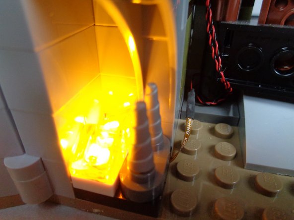 Connect the small plug from the end of the fireplace light cable to the SMALL connector on the testing board.