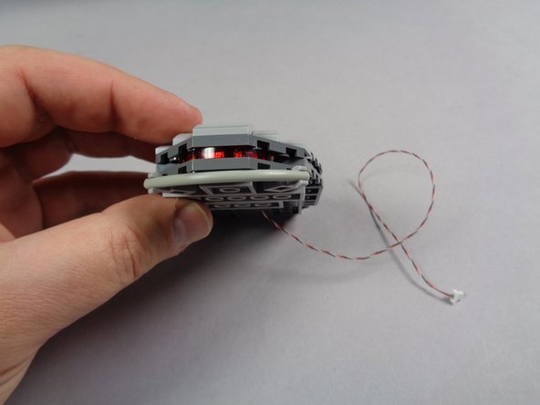 Re-attach the remaining lower head parts as shown in the second photo.