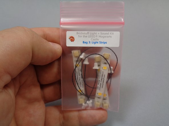 Open Bag 3, which should contain three light strips, two short connecting cables, and one longer black connecting cable.