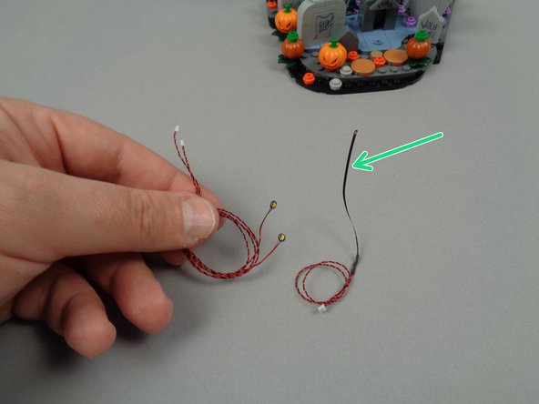 As shown by the green arrow in the second photo for this step, you will be using the LED light with the long black stem.