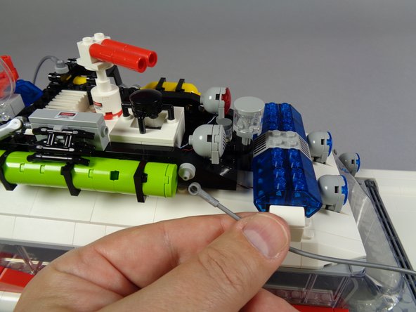 The first photo for this step shows the last hose part to re-attach.