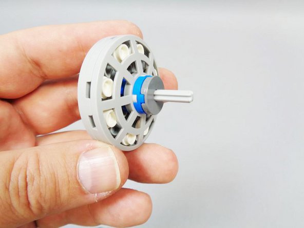 Insert the second light bluish gray axle provided with this light kit into the top of the console assembly (which you removed at the beginning of the installation process).