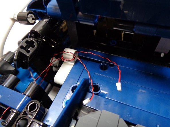 As shown in the second photo, you can wind the front and rear turn signal wires around the Technic bracket if you have excess wire length.