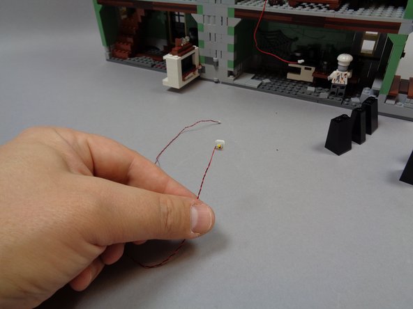 As shown in the third photo, take one of the warm white Pico LED lights with 12&quot; (30.4cm) wire and attach a small sticky square to the back.