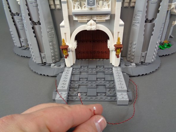 You should now have both front torches re-attached with their wires hidden beneath the rock and stair pieces as outlined in the previous steps.