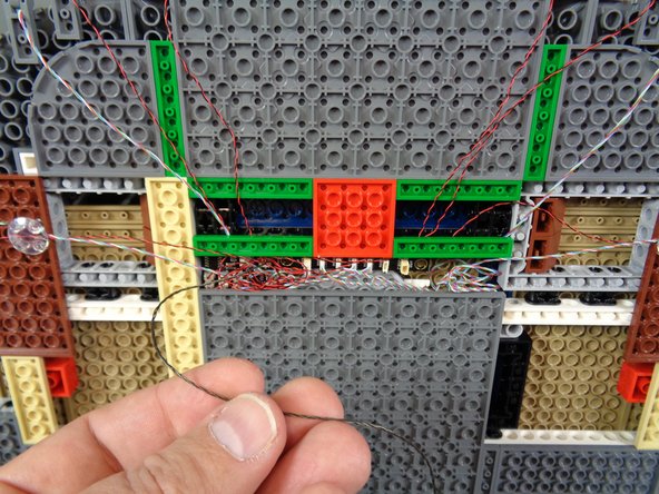 As shown in the photos for this step, carefully take the 3-wire cable that is connected to the BRANCH09XS adapter board and feed it through the hole in the bottom of the castle floor that you made earlier.