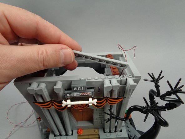 Next you will prepare to mount a warm white LED light behind the pumpkin banner on the front of the town hall.