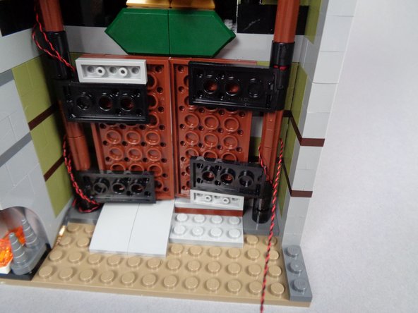 The green arrows in the third photo for this step show the light wire looping up and around the front door hinge.