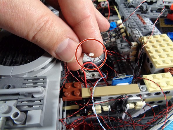 As shown in the first photo for this step, locate the small plug that leads to the hyperdrive lights.  You disconnected this at the beginning of installing your upgrade kit, but did not re-connect it.