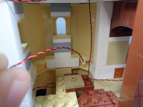 As shown in the photos for this step, run the wires for the kitchen and spinning room lights only down under the spinning room floor.