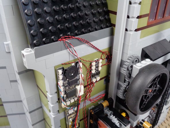 As shown in the third photo for this step, make sure all wires pass OVER the top of the panel, not underneath it.