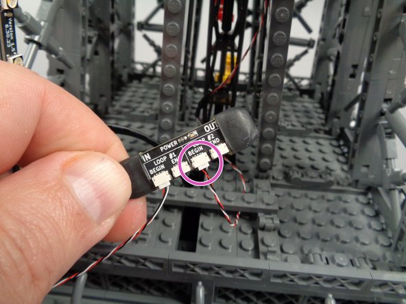 As shown by the purple circle in the second photo for this step, connect the control wire to the "BEGIN" plug in the "LOOP #2" section of the inter-level connecting board.