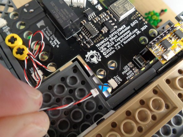 As shown in the first photo for this step, take one of the BRANCH12X driver boards out of its bag, and connect one of the long 3-wire control cables to the INPUT connecting plug on the BRANCH12X driver board.