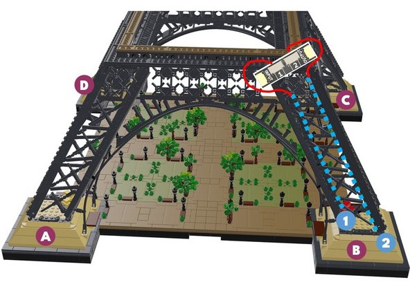 Next, you will rotate your Eiffel tower in a clockwise direction-- this is the same direction the loose control cable from the previous step is pointing toward.