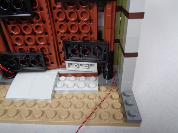 As shown by the photos in this step, loop the second porch light wire around the right front door hinge 2-3 times, as you've done before for the wires on the left door side.