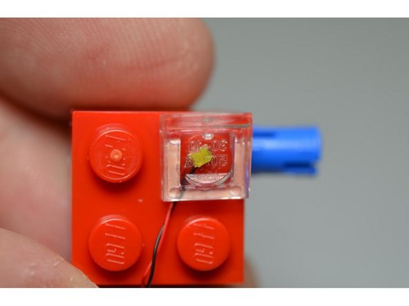 Remove the four transparent 1x1 LEGO® slopes from Bag #2 of the kit.  You will use these to snap on top of the STP LEDs and mount them in place as the new headlights.