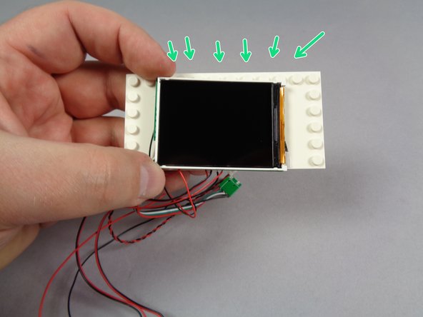 As shown in the second photo, carefully remove the video player from its anti-static bag and position it in the center of the large white plate.