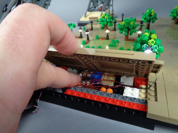 As shown in the first photo for this step, make sure all light wires are gathered underneath Panel 1F, and also that the BRANCH12X driver board is positioned under the panel with enough space that the panel will not crush the driver board when you re-attach it.