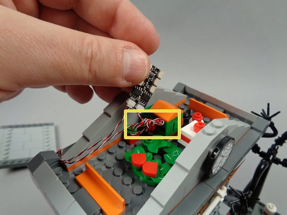 As shown by the yellow rectangle in the photo for this step, coil up any excess wire from the fountain light strip close to the BRANCH06X driver board in the attic.