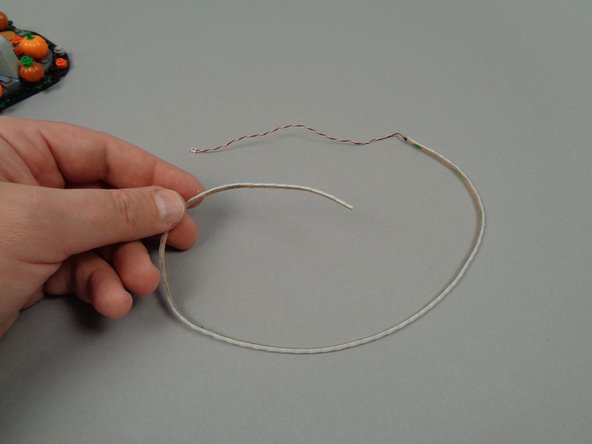 As shown in the second and third photos for this step, remove the light strip from its pink bag (this was provided inside Bag 1 of your light kit).