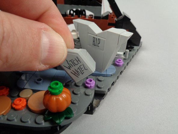 As shown in the photos for this step, remove the WITCH HAZEL tombstone and remove the tile and slopes on the back side of the tombstone.