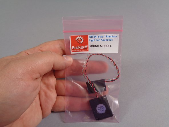 The last large pink bag in your kit will be labeled &quot;SOUND MODULE&quot;.  Remove the module and its small speaker as shown in the second photo.