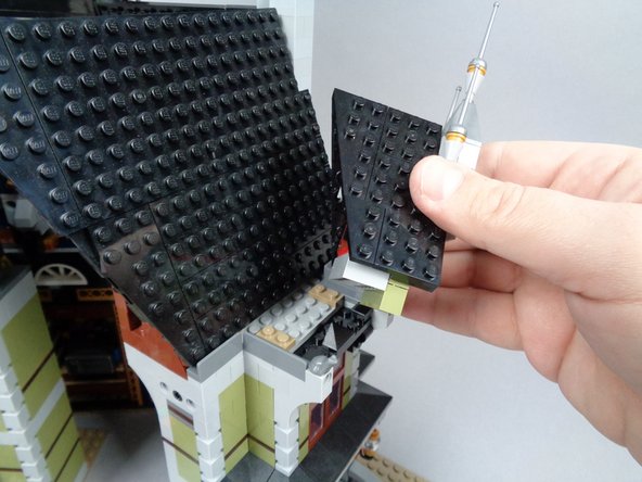 As shown in the photos for this step, remove the roof section above the front alcove window (above the front door), then remove the other pieces as shown in the second and third photos.