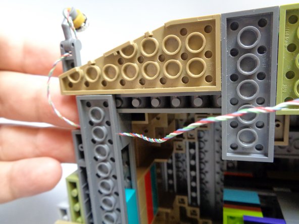 When attaching each spotlight around the castle base, make sure to run the wires on top of the bottom plates so no wires run under plates and rub against the base when the castle is upright.